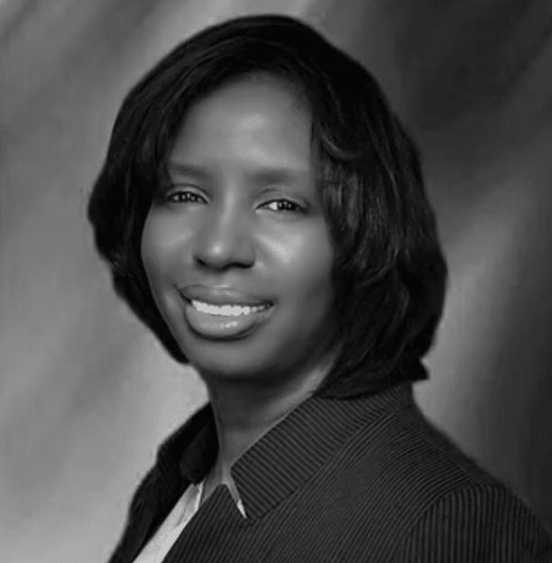 A smiling Black woman with short, dark hair wearing a striped shirt.