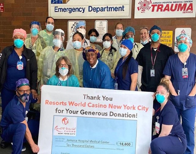 Emergency department staff holding a $10,000 donation check from Resorts World Casino New York City.